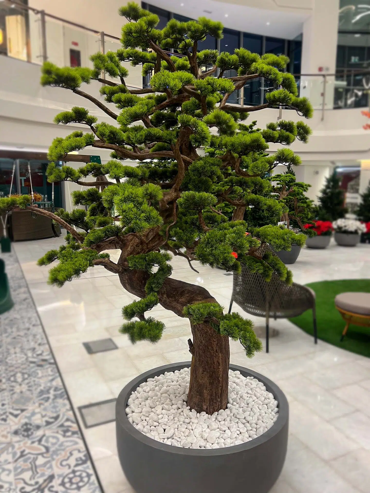 Elevate your space with this stunning Artificial Bonsai Tree! Its realistic design and stylish pot will bring everlasting beauty to any setting.