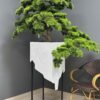 Elevate your space with this stunning Artificial Bonsai Tree! Its realistic design and stylish pot will bring everlasting beauty to any setting.